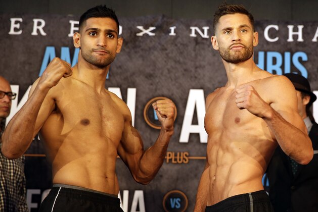 Boxers Amir Khan, left and Chris Algieri pose for photographers during their weigh-in, Thursday, May 28, 2015, in New York, The pair square off Friday night in a welterweight fight at the Barclays Center in Brooklyn. (AP Photo/Mary Altaffer)