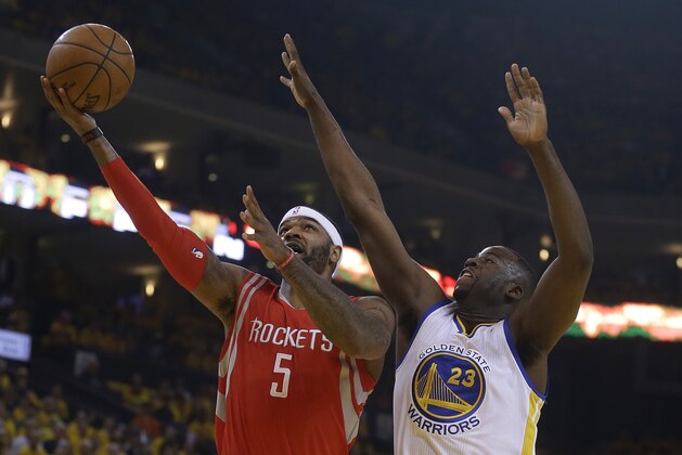 Houston Rockets forward Josh Smith (5) shoots against Golden State Warriors forward Draymond Green (23) during the first half of Game 5 of the NBA basketball Western Conference finals in Oakland, Calif., Wednesday, May 27, 2015. (AP Photo/Ben Margot)