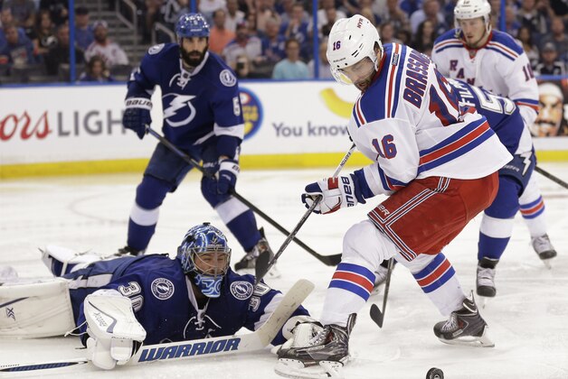 New York Rangers center Derick Brassard (16) watches as the puck is deflected on a save by Tampa Bay Lightning goalie Ben Bishop (30) during the third period of Game 6 of the Eastern Conference finals in the NHL hockey Stanley Cup playoffs, Tuesday, May 26, 2015, in Tampa, Fla. (AP Photo/Chris O'Meara)