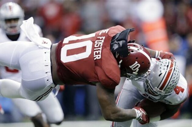 Alabama linebacker Reuben Foster (10) hits Ohio State running back Curtis Samuel (4) in the first half of the Sugar Bowl NCAA college football playoff semifinal game, Thursday, Jan. 1, 2015, in New Orleans. (AP Photo/Brynn Anderson)