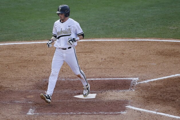 Vanderbilt Dansby Swanson passes home plate after scoring a home run  during the fourth inning of a Southeastern Conference college baseball tournament game against Texas A&M at the Hoover Met, Thursday, May 21, 2015, in Hoover, Ala. (AP Photo/Brynn Anderson)