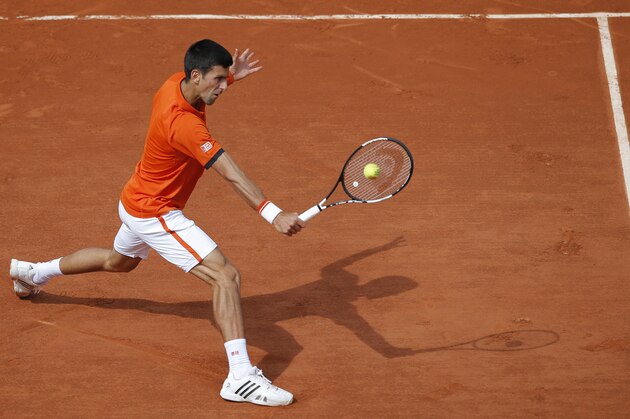 Serbia's Novak Djokovic returns in the second round match of the French Open tennis tournament against Luxembourg's Gilles Muller at the Roland Garros stadium, in Paris, France, Thursday, May 28, 2015. (AP Photo/Francois Mori)