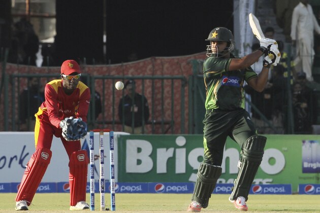 Pakistan's Azhar Ali, right, plays a shot as Zimbabwe's wicketkeeper Richmond Mutumbami looks on during their 1st one-day international match at Gaddafi Stadium in Lahore, Pakistan, Tuesday, May 26, 2015. (AP Photo/K.M. Chaudary)