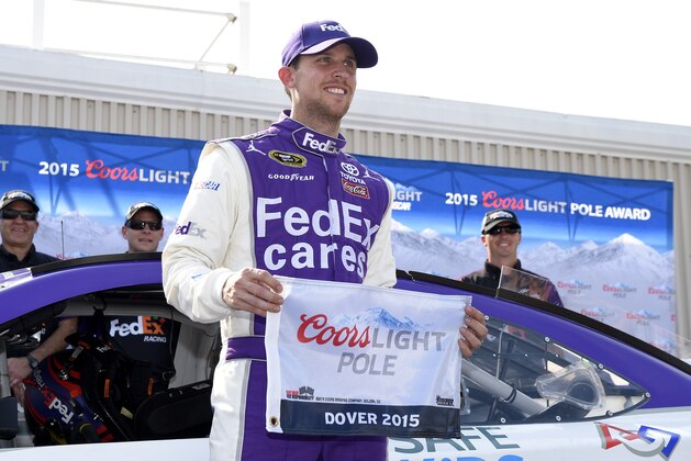 Denny Hamlin poses with the pole award after he won the position for Sunday's NASCAR Sprint Cup series auto race, Friday, May 29, 2015, at Dover International Speedway in Dover, Del. (AP Photo/Nick Wass)