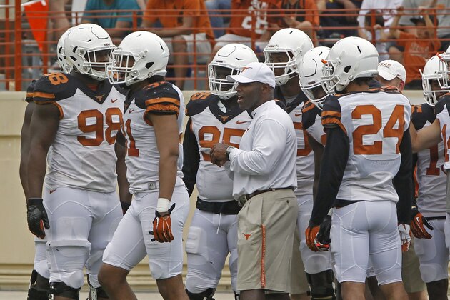 Texas head coach Charlie Strong stands with his team during the first quarter of Texas' Orange and White spring NCAA college football game, Saturday, April 18, 2015, in Austin, Texas. (AP Photo/Michael Thomas)