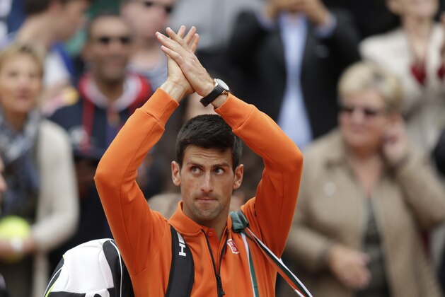 Serbia's Novak Djokovic applauds after defeating Luxembourg's Gilles Muller during their second round match of the French Open tennis tournament at the Roland Garros stadium, Thursday May 28, 2015 in Paris. (AP Photo/Thibault Camus)