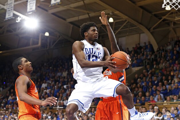 Duke's Justise Winslow (12) drives to the basket past Clemson defenders during the first half of an NCAA college basketball game, Saturday, Feb. 21, 2015, in Durham, N.C. (AP Photo/Karl B DeBlaker)