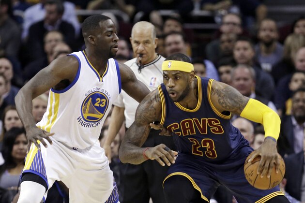 Cleveland Cavaliers' LeBron James, right, drives past Golden State Warriors’ Draymond Green during the first quarter of an NBA basketball game Thursday, Feb. 26, 2015, in Cleveland. (AP Photo/Tony Dejak)