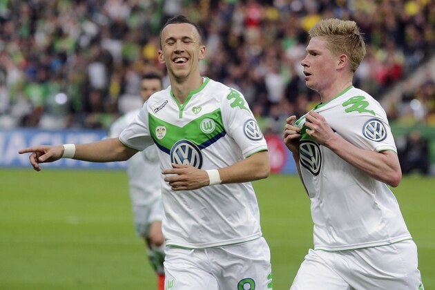 Wolfsburg's Kevin De Bruyne from Belgium, right, and Wolfsburg's Vieirinha from Portugal celebrate after scoring during the German soccer cup final match between Borussia Dortmund and VfL Wolfsburg in Berlin, Germany, Saturday, May 30, 2015. (AP Photo/Markus Schreiber)