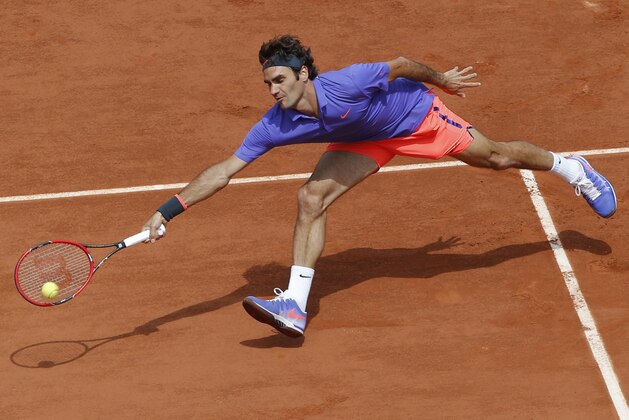 Switzerland's Roger Federer returns in the third round match of the French Open tennis tournament against Bosnia and Herzegovina's Damir Dzumhur at the Roland Garros stadium, in Paris, France, Friday, May 29, 2015. (AP Photo/Michel Euler)