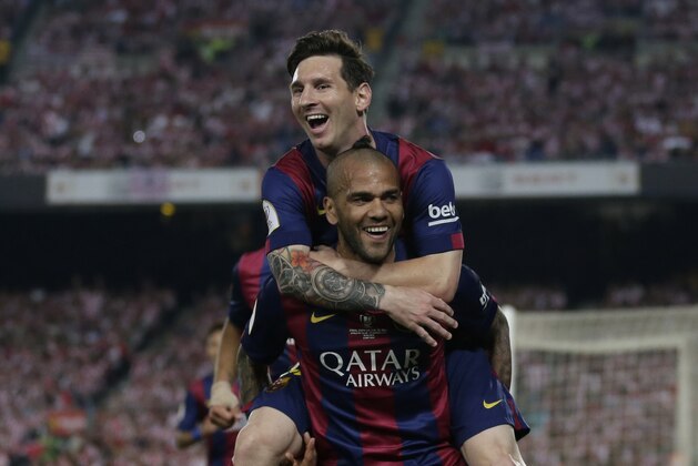 Barcelona's Lionel Messi, left, celebrates with Dani Alves after scoring his side’s third goal during the final of the Copa del Rey soccer match between FC Barcelona and Athletic Bilbao at the Camp Nou stadium in Barcelona, Spain, Saturday, May 30, 2015. (AP Photo/Manu Fernandez)