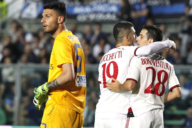 AC Milan's Giacomo Bonaventura, right, is congratulated by his teammate Salvatore Bocchetti, after he scored during a Serie A soccer match against Atalanta in Bergamo, Italy, Saturday, May 30, 2015. (AP Photo/Felice Calabro')