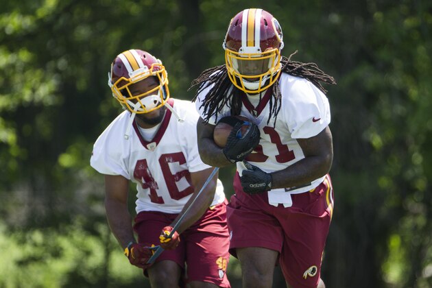 Washington Redskins running backs Alfred Morris, left, and Matt Jones take part in a drill during an NFL football organized team activity at Redskins Park, on Tuesday, May 26, 2015, in Ashburn, Va. (AP Photo/Evan Vucci)
