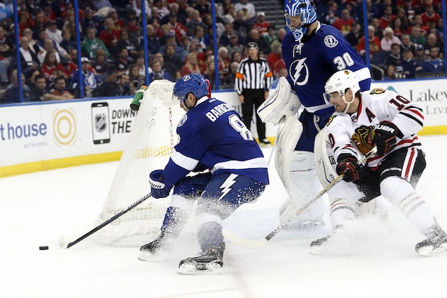 Tampa Bay Lightning goalie Ben Bishop (30) and defenseman Mark Barberio (8) defend against Chicago Blackhawks left wing Patrick Sharp (10) during the third period of an NHL hockey game Friday, Feb. 27, 2015, in Tampa, Fla. (AP Photo/Brian Blanco)