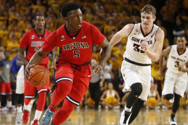 Arizona forward Stanley Johnson (5) drives past Arizona State guard Bo Barnes (33) during the second half of an NCAA college basketball game, Saturday, Feb. 7, 2015, in Tempe, Ariz. (AP Photo/Rick Scuteri)