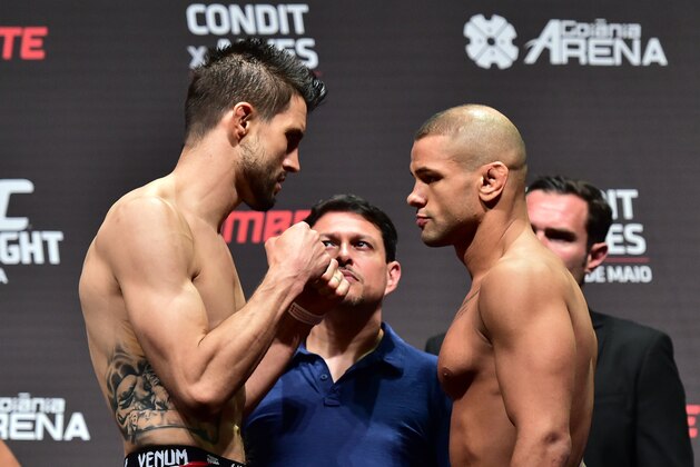 May 29, 2015; Goiania, GO, Brazil; Carlos Condit (left) and Thiago Alves  face off at the weigh-in for their fight at UFC Fight Night at Goiania Arena. Mandatory Credit: Jason Silva-USA TODAY Sports