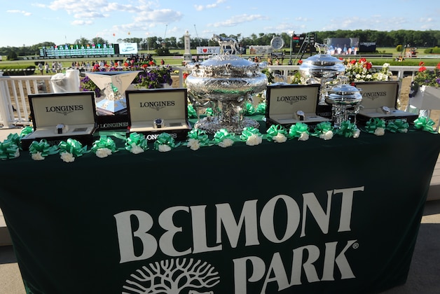 IMAGE DISTRIBUTED FOR LONGINES - Longines timepieces are displayed next to the elusive Triple Crown trophy, left, and the August Belmont Trophy, center, Saturday, June 7, 2014, before the 146th running of the Belmont Stakes at Belmont Park in New York.  Longines, the Swiss watchmaker known for its elegant timepieces, is the Official Watch and Timekeeper of the 146th running of the Belmont Stakes. (Photo by Diane Bondareff/Invision for Longines/AP Images)