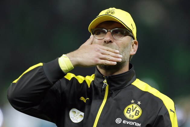 Dortmund's head coach Juergen Klopp covers his face after his team lost the German soccer cup final match between Borussia Dortmund and VfL Wolfsburg in Berlin, Germany, Saturday, May 30, 2015. (AP Photo/Markus Schreiber)
