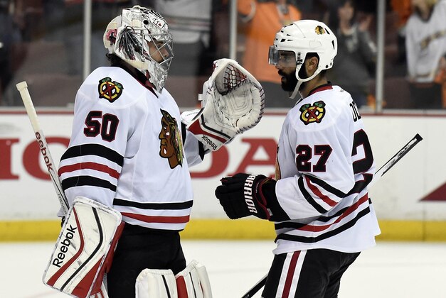 May 30, 2015; Anaheim, CA, USA; Chicago Blackhawks goalie Corey Crawford (50) and defenseman Johnny Oduya (27) celebrate the 5-3 victory against the Anaheim Ducks following game seven of the Western Conference Final of the 2015 Stanley Cup Playoffs at Honda Center. Mandatory Credit: Gary A. Vasquez-USA TODAY Sports