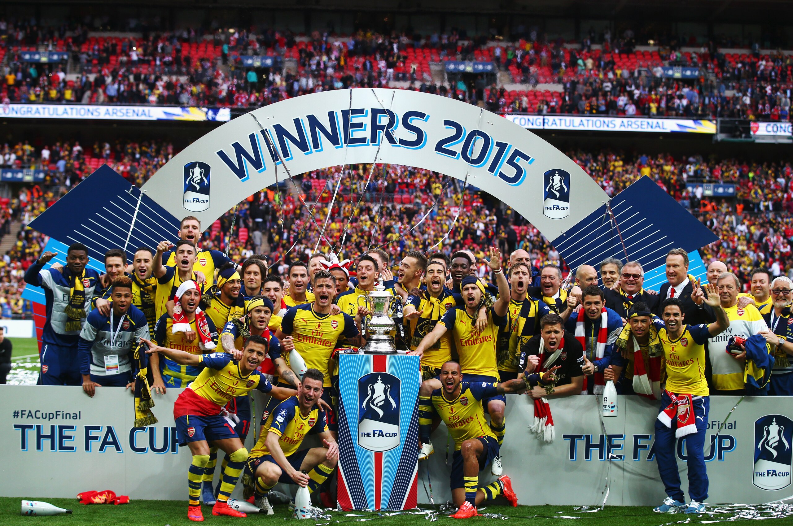 LONDON, ENGLAND - MAY 30:  Arsenal players celebrate with the trophy after the FA Cup Final between Aston Villa and Arsenal at Wembley Stadium on May 30, 2015 in London, England. Arsenal beat Aston Villa 4-0.  (Photo by Clive Rose/Getty Images)