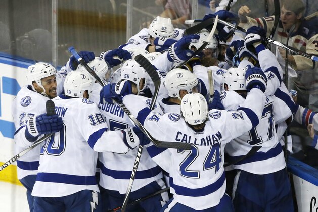 The Tampa Bay Lightning celebrate their 2-0 win over the New York Rangers in Game 7 of the Eastern Conference final during the NHL hockey Stanley Cup playoffs, Friday, May 29, 2015, in New York. (AP Photo/Kathy Willens)