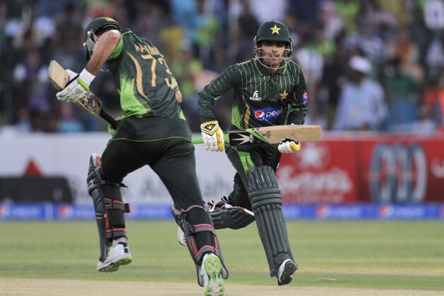 Pakistan's Baber Azam, right, and Hammad Azam run between the wickets during third one-day international match against Zimbabwe at Gaddafi Stadium in Lahore, Pakistan, Sunday, May 31, 2015. (AP Photo/K. M. Chaudary)