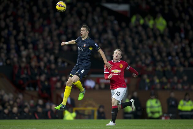 Southampton's Morgan Schneiderlin, left, keeps the ball from Manchester United's Wayne Rooney during the English Premier League soccer match between Manchester United and Southampton at Old Trafford Stadium, Manchester, England, Sunday Jan. 11, 2015. (AP Photo/Jon Super)