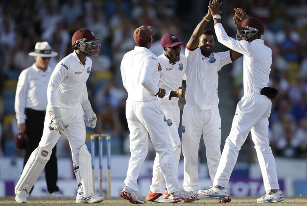 West Indies' bowler Veerasammy Permaul, second from right, celebrates with teammates after dismissing England's Moeen Ali during day two of their third Test match at the Kensington Oval in Bridgetown, Barbados, Saturday, May 2, 2015.  (AP Photo/Ricardo Mazalan)