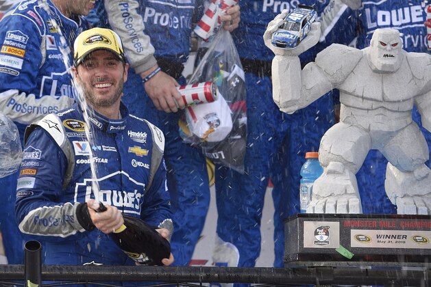 Jimmie Johnson sprays sparking wine as he celebrates in Victory Lane after he won the NASCAR Sprint Cup series auto race, Sunday, May 31, 2015, at Dover International Speedway in Dover, Del. (AP Photo/Nick Wass)