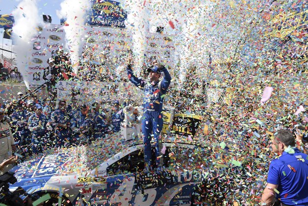 Jimmie Johnson celebrates in Victory Lane after he won the NASCAR Sprint Cup series auto race, Sunday, May 31, 2015, at Dover International Speedway in Dover, Del. (AP Photo/Nick Wass)