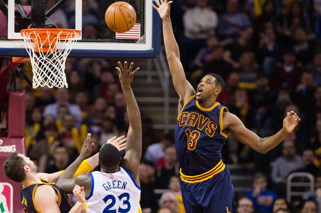 CLEVELAND, OH - FEBRUARY 26: Kevin Love #0 and Tristan Thompson #13 of the Cleveland Cavaliers try to stop Draymond Green #23 of the Golden State Warriors during the second half at Quicken Loans Arena on February 26, 2015 in Cleveland, Ohio. The Cavaliers defeated the Warriors 110-99. NOTE TO USER: User expressly acknowledges and agrees that, by downloading and or using this photograph, User is consenting to the terms and conditions of the Getty Images License Agreement. (Photo by Jason Miller/Getty Images)