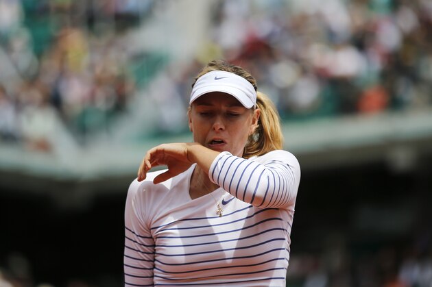 Russia's Maria Sharapova wipes her face as she plays Lucie Safarova of the Czech Republic during their fourth round match of the French Open tennis tournament at the Roland Garros stadium, Monday, June 1, 2015 in Paris, France. (AP Photo/Christophe Ena)