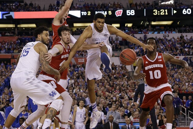 Kentucky's Karl-Anthony Towns, center, goes after a rebound against Wisconsin's Frank Kaminsky  during the second half of the NCAA Final Four tournament college basketball semifinal game Saturday, April 4, 2015, in Indianapolis. (AP Photo/David J. Phillip)