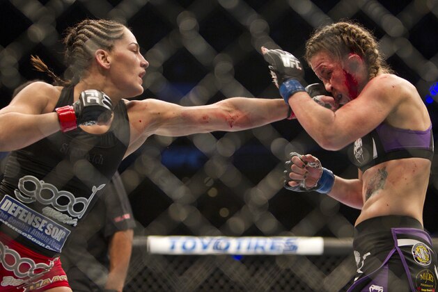 Jessica Eye, left, of the United States, battles against Leslie Smith, also of the United States, during a UFC mixed martial arts fight in Mexico City, Saturday, Nov. 15, 2014. (AP Photo/Christian Palma)