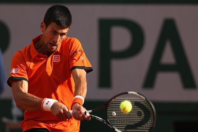 PARIS, FRANCE - JUNE 01:  Novak Djokovic of Serbia plays a backhand in his Men's Singles match against Richard Gasquet of France on day eight of the 2015 French Open at Roland Garros on May 31, 2015 in Paris, France.  (Photo by Clive Brunskill/Getty Images)