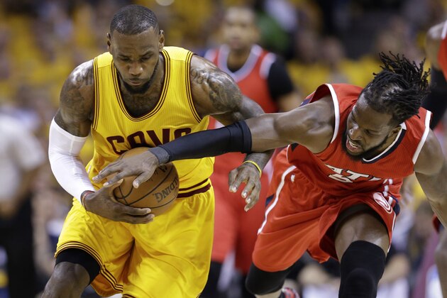 Atlanta Hawks forward DeMarre Carroll (5) tries to strip the ball from Cleveland Cavaliers forward LeBron James (23) in the first quarter of Game 4 of the NBA basketball Eastern Conference Finals, Tuesday, May 26, 2015, in Cleveland. (AP Photo/Tony Dejak)