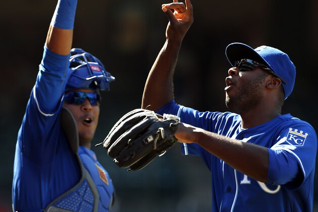 Kansas City Royals' Lorenzo Cain, right, and catcher Salvador Perez celebrate after a 9-2 win over the Los Angeles Angels in a baseball game, Sunday, April 12, 2015, in Anaheim, Calif. (AP Photo/Christine Cotter)