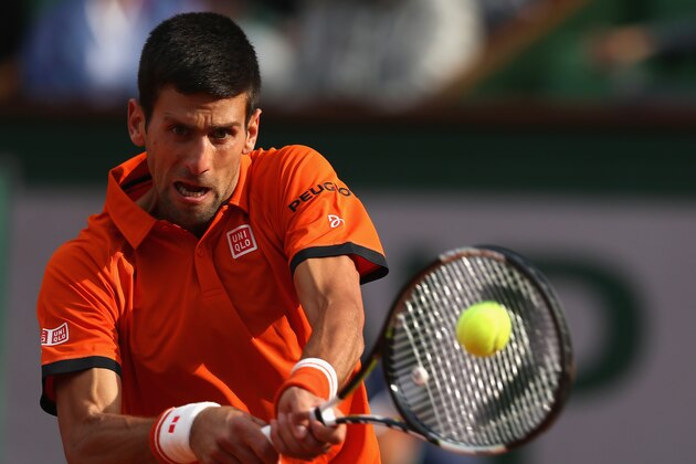 PARIS, FRANCE - JUNE 01:  Novak Djokovic of Serbia plays a backhand in his Men's Singles match against Richard Gasquet of France on day nine of the 2015 French Open at Roland Garros on June 1, 2015 in Paris, France.  (Photo by Clive Brunskill/Getty Images)