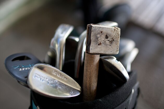 This Tuesday, Oct. 21, 2014 photo, shows Dylan Reales' golf bag that contains his first golf club, constructed from a wooden broomstick, mixed in with his professional clubs, in Buenos Aires, Argentina. Reales started learning to play golf by swinging the broken broomstick at fruit and vegetables discarded at a temporary market set up in front of his house in one of the poorest neighborhoods in Buenos Aires. (AP Photo/Natacha Pisarenko)