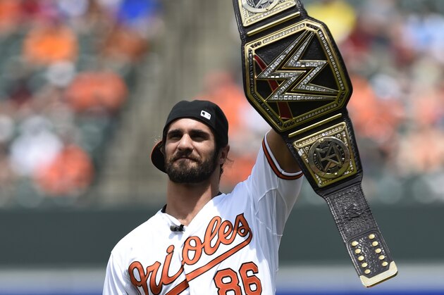 WWE world heavyweight champion Seth Rollins addresses the crowd before throwing out the ceremonial first pitch before the Baltimore Orioles and Los Angeles Angels baseball game, Sunday, May 17, 2015 in Baltimore. (AP Photo/Gail Burton)