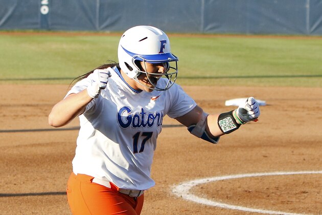 Florida's Lauren Haeger celebrates on the way home after hitting a home run in the first inning during the NCAA Women's College World Series Championship against Michigan in Oklahoma City, Monday, June 1, 2015. (AP Photo/Alonzo Adams)