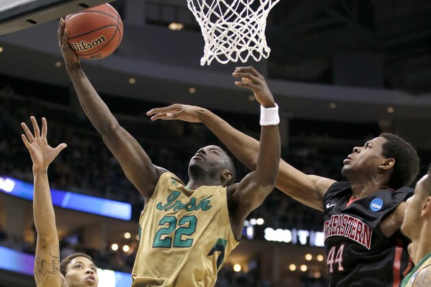 Notre Dame's Jerian Grant (22) shoots around Northeastern's Reggie Spencer, right, during the first half of a second round game in the NCAA college basketball tournament, Thursday, March 19, 2015, in Pittsburgh. (AP Photo/Gene J. Puskar)