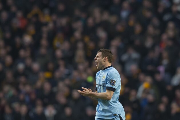 Manchester City's James Milner celebrates after scoring  during the English Premier League soccer match between Manchester City and Hull at the Etihad Stadium, Manchester, England, Saturday Feb. 7, 2015. (AP Photo/Jon Super)