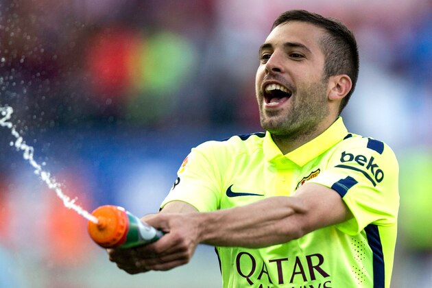 MADRID, SPAIN - MAY 17:  Jordi Alba of Barcelona  celebrates as they the title after the La Liga match between Club Atletico de Madrid and FC Barcelona at Vicente Calderon Stadium on May 17, 2015 in Madrid, Spain. Barcelona are champions after a 1-0 victory.  (Photo by Gonzalo Arroyo Moreno/Getty Images)