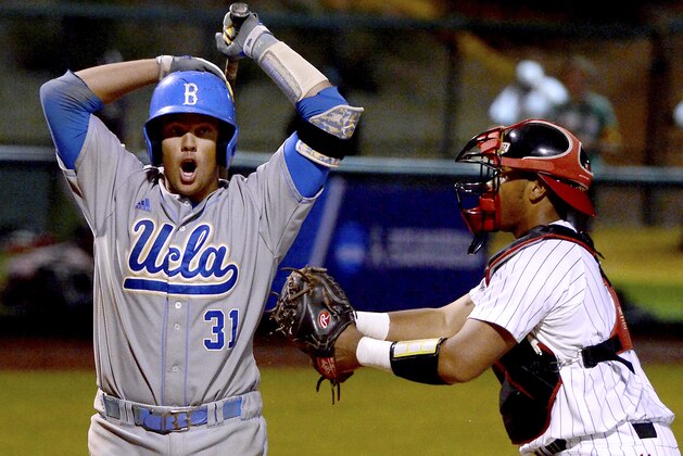 UCLA's Darrell Miller Jr. is tagged out on a dropped third strike by Maryland's Kevin Martir for the last out of the ninth inning during the NCAA college baseball tournament regional game in Los Angeles on Monday, June 1, 2015. Maryland won 2-1. (AP Photo/Jayne Kamin-Oncea)