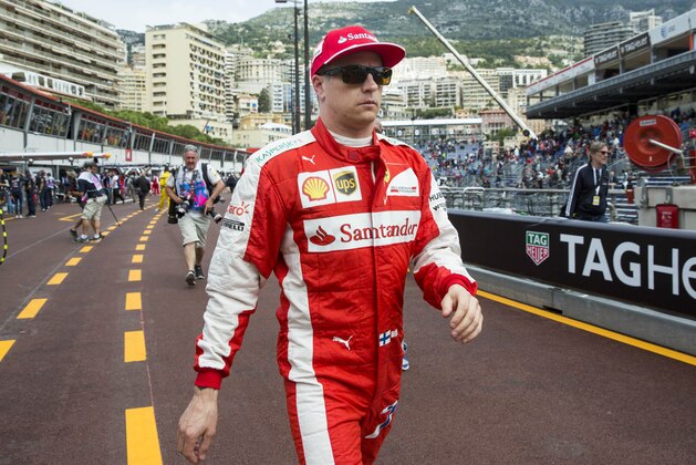 Ferrari driver Kimi Raikkonen of Finland walks through the pit lane after the first practice session at the Monaco racetrack, in Monaco, Thursday, May 21, 2015. The Formula One Grand Prix of Monaco will be held on Sunday. (AP Photo/Gero Breloer)