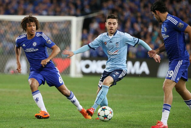 Chelsea's Nathan Ake, left, passes the ball to teammate Diego Costa, right, past Sydney FC's defender Christopher Naumoff, centre, during their friendly soccer match in Sydney, Tuesday, June 2, 2015. (AP Photo/Rick Rycroft)