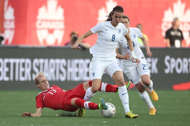 HAMILTON, CANADA - MAY 29: Sophie Schmidt #13 of Canada takes the ball away from Jill Scott #8 of England during their Women's International Friendly match on May 29, 2015 at Tim Hortons Field in Hamilton, Ontario, Canada. (Photo by Tom Szczerbowski/Getty Images)