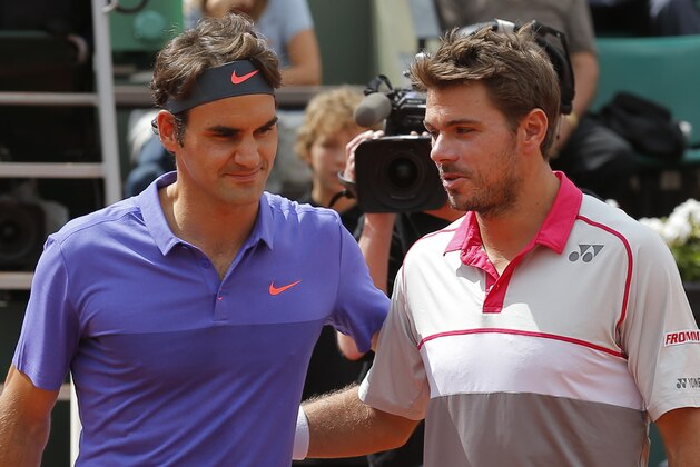 Switzerland's Roger Federer, left, and Switzerland's Stan Wawrinka pose for photographers prior to their quarterfinal match of the French Open tennis tournament against at the Roland Garros stadium, in Paris, France, Tuesday, June 2, 2015. (AP Photo/Francois Mori)
