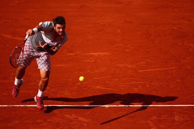 PARIS, FRANCE - JUNE 02:  Stanislas Wawrinka of Switzerland serves in his Men's quarter final match against Roger Federer of Switzerland on day of the 2015 French Open at Roland Garros on June 2, 2015 in Paris, France.  (Photo by Clive Brunskill/Getty Images)